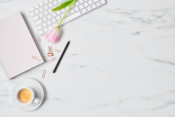 istock Office desk with computer and tulip flower 1129451985