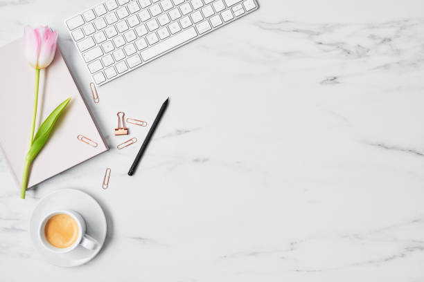 istock Office desk with computer and tulip flower 1129451986