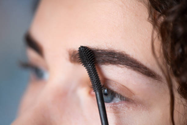 istock Young woman undergoing eyebrow correction procedure. Eyebrow Mascara 1129452865