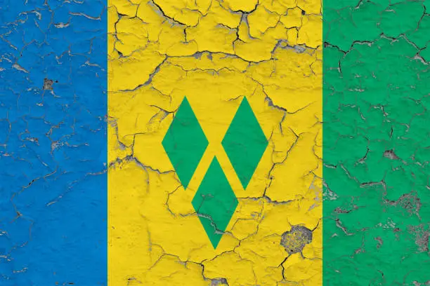 Flag of Saint Vincent And The Grenadines painted on cracked dirty wall. National pattern on vintage style surface.