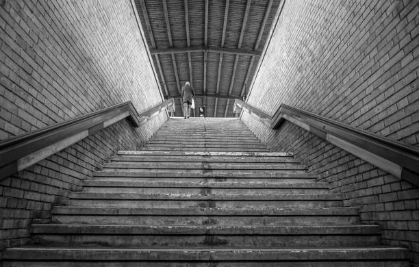 istock Low Angle View Of Person Climbing Staircase 1129454929
