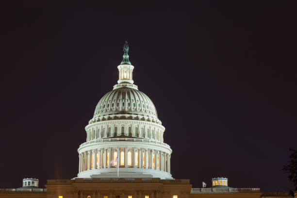 istock US capitol building at night.  Dome close-up. 1129455541