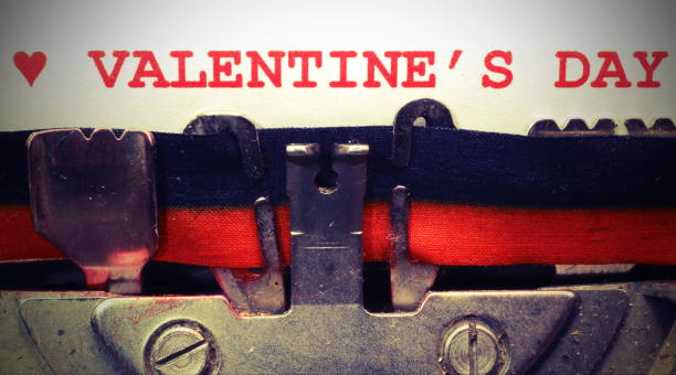 istock text by typewriter Valentines Day in red ink with vintage toned 1129455704