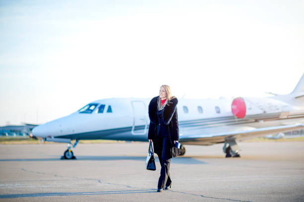 istock Young businesswoman leaving private jet airplane 1129457664