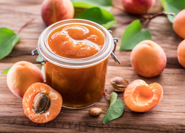 istock Apricot jam and ripe apricots. 1129457935