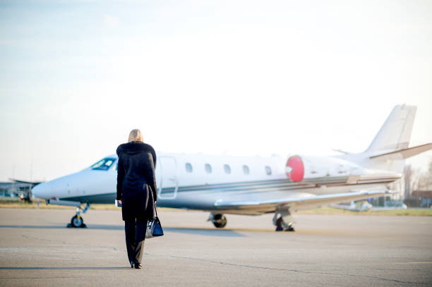 istock Young businesswoman going to private jet airplane 1129457959