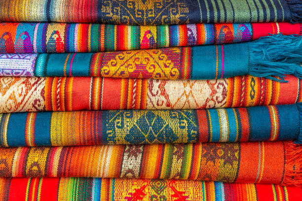Andes Textiles in Otavalo, Ecuador A pile of colorful Andes textiles on the sunday art and craft market of Otavalo in Ecuador, north of Quito. bolivian andes photos stock pictures, royalty-free photos & images