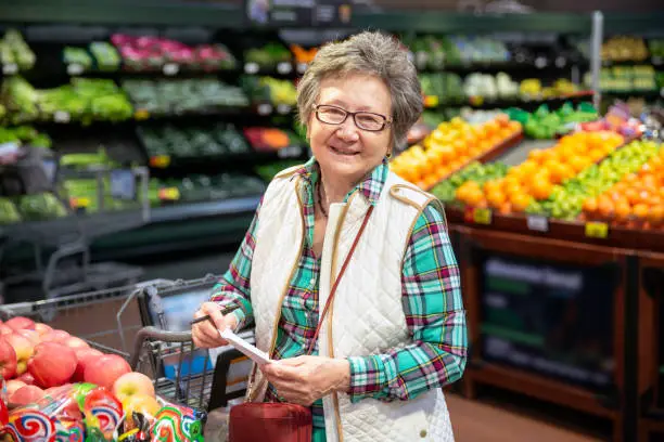 Senior woman shopping for produce.