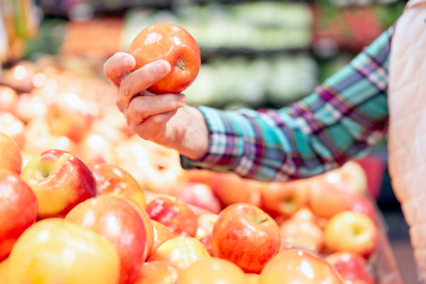 istock Senior woman picking apples. 1129459363