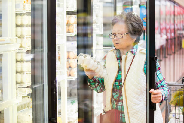 istock Senior woman in a grocery store. 1129459375