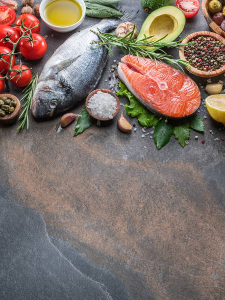 istock Raw dorado fish and salmon steak with spices and vegetables. 1129459829
