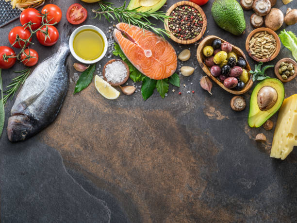 istock Raw dorado fish and salmon steak with spices and vegetables. 1129459869