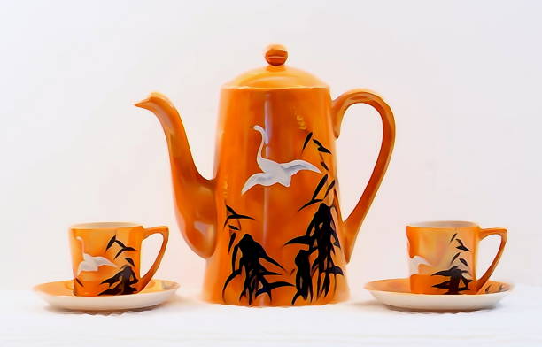 istock Vintage beautiful china  tea-pot with matching  delicate tiny cups and saucers 1129462772