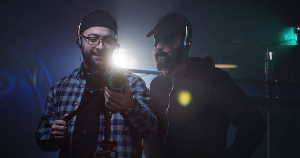 istock Filmmakers setting photo camera on stage 1129464255