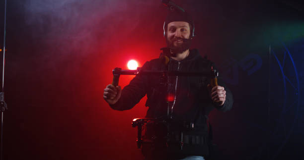 Bearded man in harness for camera equipment