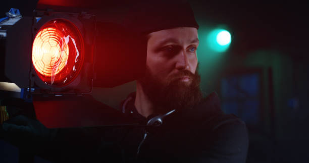 istock Man putting red glass on lamp 1129464273