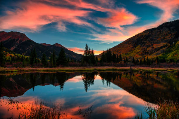 istock Colorful Panoramic Mountain View at Sunrise Reflecting in Lake 1129473339