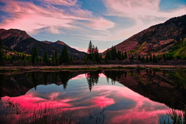 istock Colorful Panoramic Mountain View at Sunrise Reflecting in Lake 1129473555