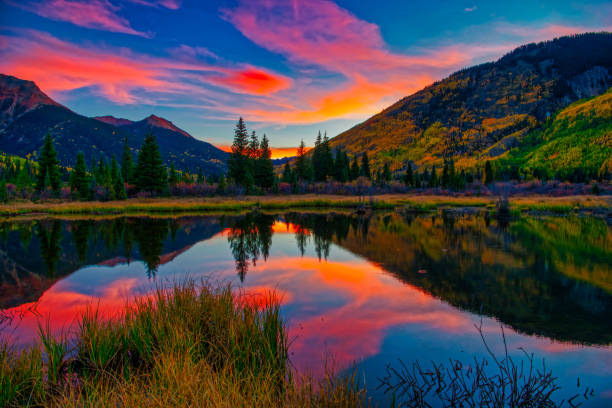 istock Colorful Panoramic Mountain View at Sunrise Reflecting in Lake 1129473592