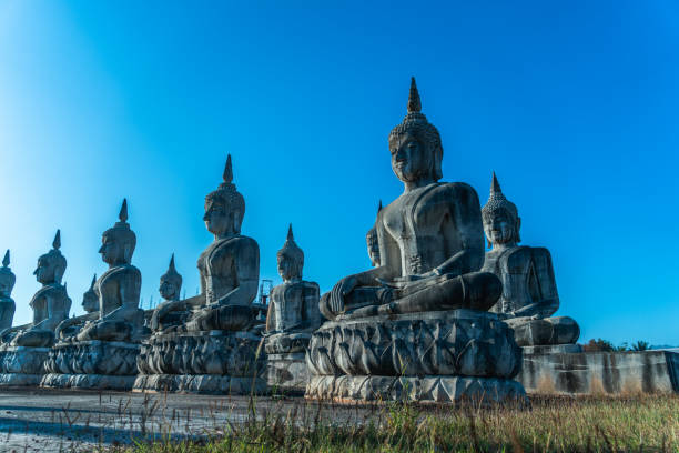 istock a lot of big Buddha statues in blue sky 1129481418