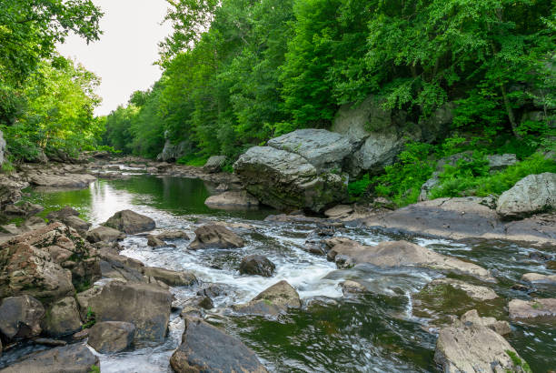 Summer afternoon at Blackstone Gorge Water flowing into Blackstone Gorge just downstream from dam at Blackstone River & Canal Heritage State Park river valleys stock pictures, royalty-free photos & images