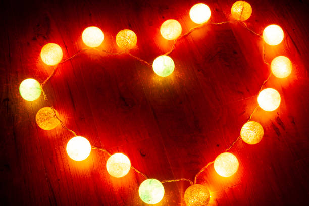 istock garland heart on wooden background 1129482576