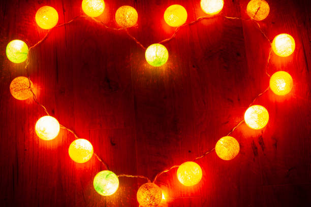 istock garland heart on wooden background 1129482579