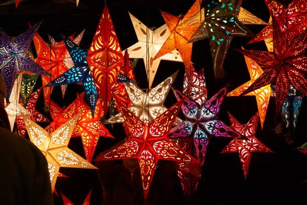 paper stars in many colors as xmas decoration against black background