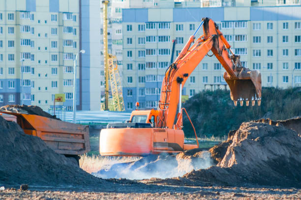 istock Excavator loads the earth into a dump truck. 1129484357