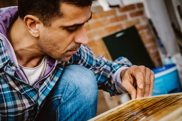 istock Male craftsman makes a wooden table 1129484381