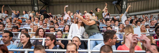 istock Two women taking selfies on a concert 1129484485