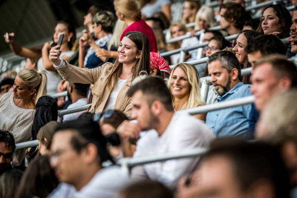 istock Young woman taking a selfie during concert 1129484488