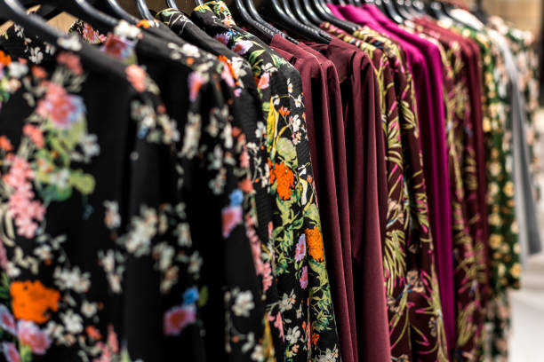 istock colorful clothes hanging on store racks 1129485851