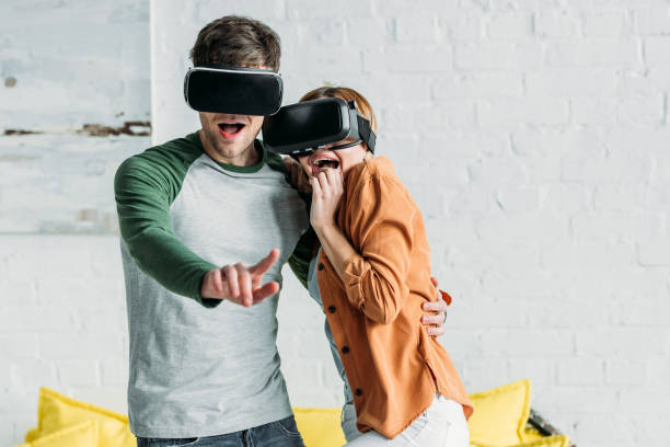 istock excited friends emotionally reacting while using virtual reality headsets 1129487834