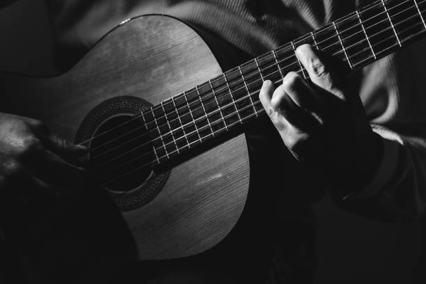istock Midsection Of Man Playing A Guitar, black And White 1129490679
