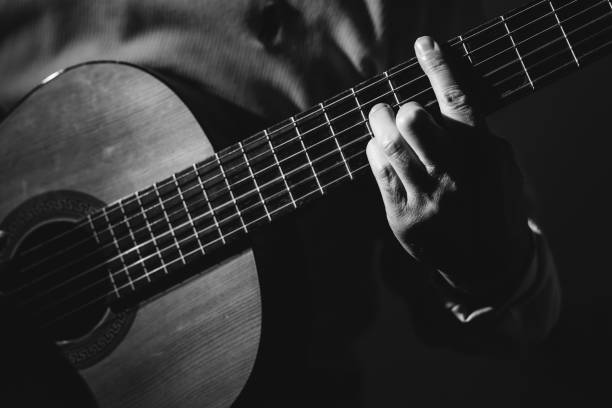 istock Midsection Of Man Playing A Guitar, black And White 1129490687