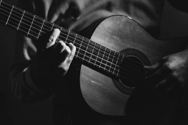 istock Midsection Of Man Playing A Guitar, black And White 1129490735