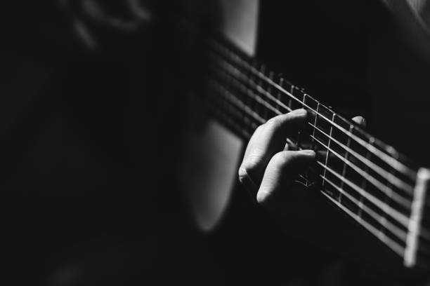 istock Midsection Of Man Playing A Guitar, black And White 1129490834