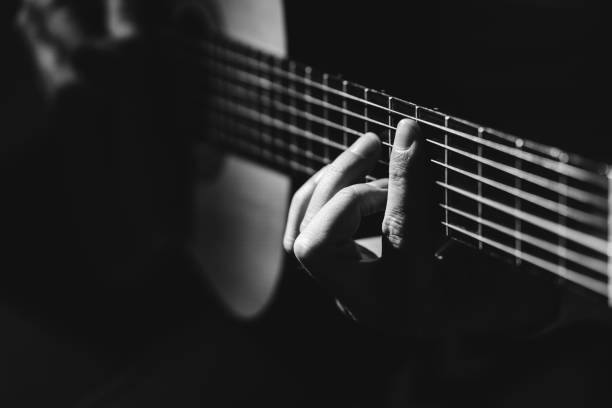 istock Midsection Of Man Playing A Guitar, black And White 1129490850