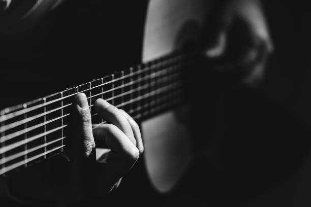istock Midsection Of Man Playing A Guitar, black And White 1129490930