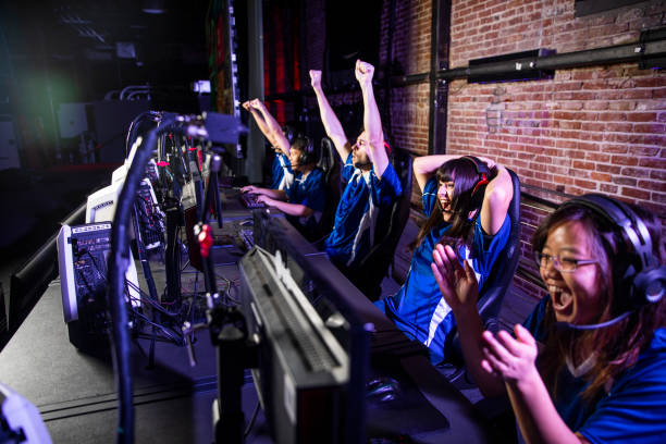 Esports Team Winning the Match Young professional esports players playing games arcade photos stock pictures, royalty-free photos & images