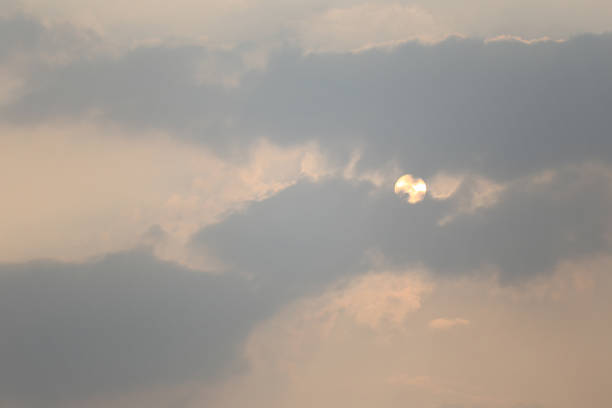 istock Sun in the evening sneak behind the clouds and there is copy space. 1129496691