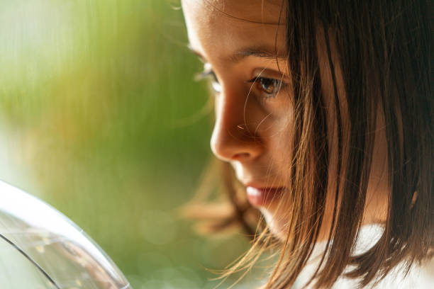 istock Teen Girl Looking at Globe 1129497611