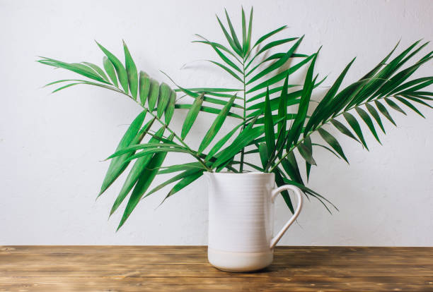 istock Stylish interior design with tropical leaves 1129498432