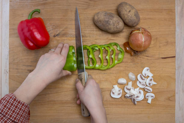 istock Slicing up vegetables on a cutting board. 1129502419