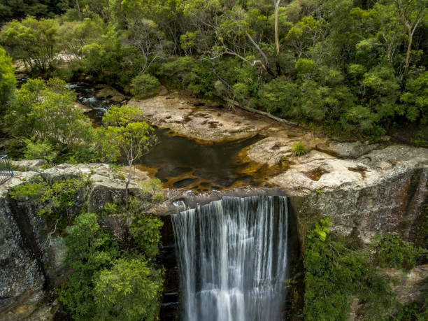 istock Bushland creek flowing over cliff top as waterfall 1129508521