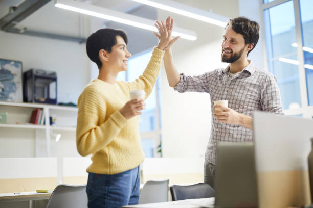 istock Excited colleagues giving high five 1129517450