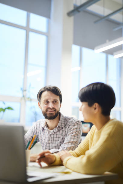istock Hipster colleagues discussing ideas in office 1129517458