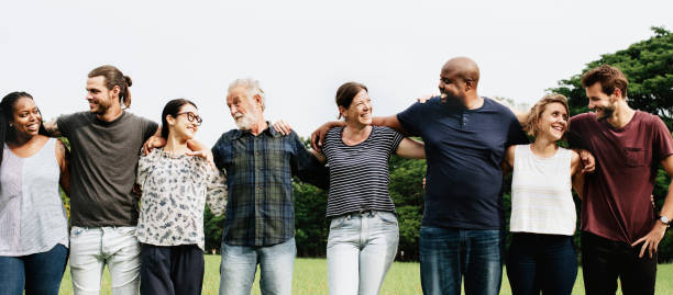 istock Group of people hugging each other in the park 1129520027
