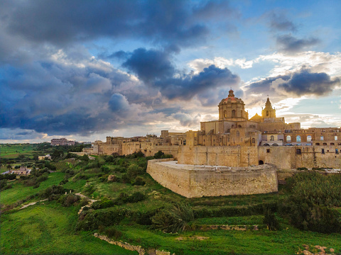 Aerial view of Mdina city - old capital of Malta country. Sunset time with  beautiful clouds and greeny